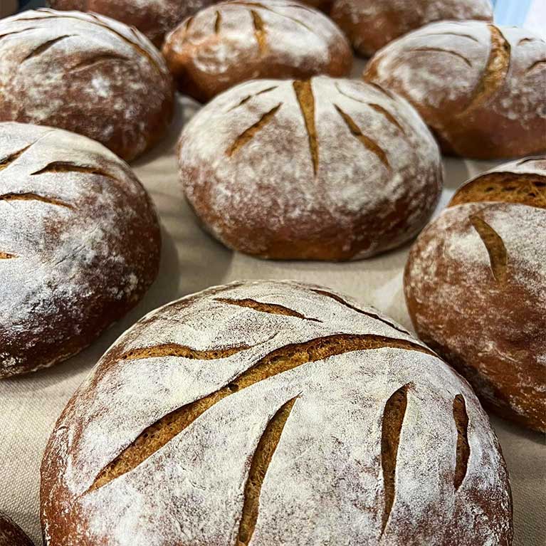 Freshly baked round loaves of bread on table