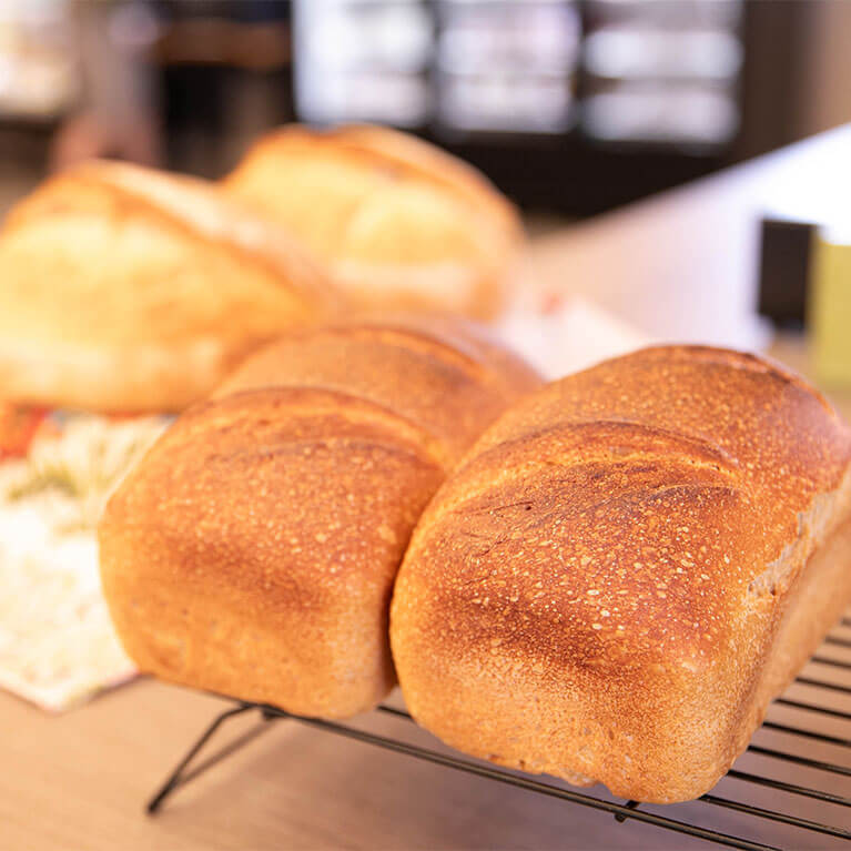 Freshly baked loaves of bread cooling