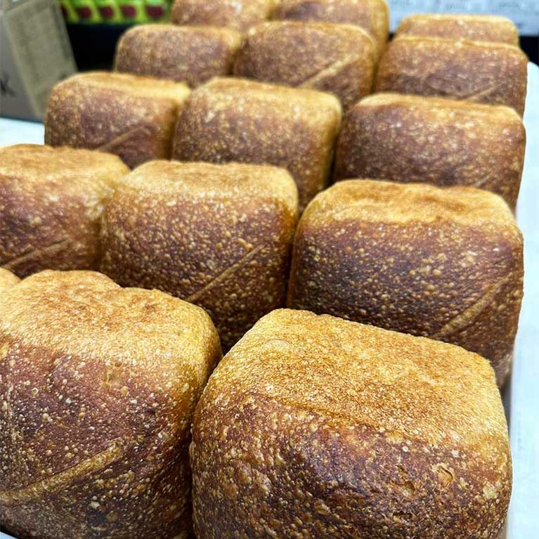 Freshly baked square loaves of bread on tray
