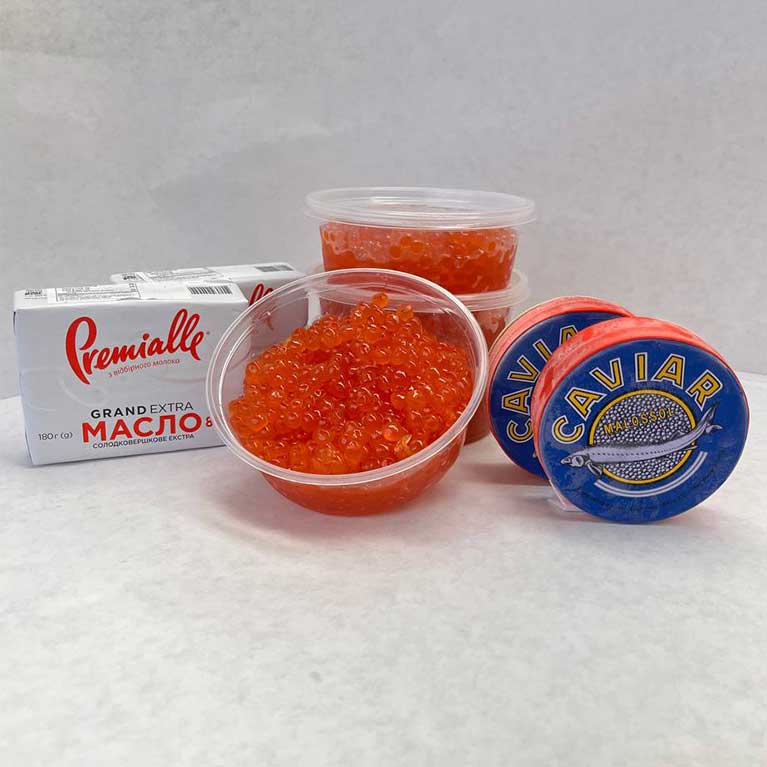 Red caviar and butter on white background
