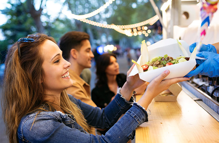 Woman receiving food at outdoor food truck