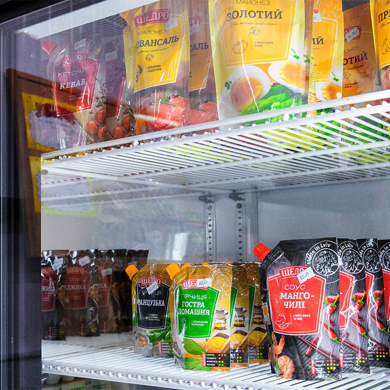Assorted condiment packets in a refrigerator display