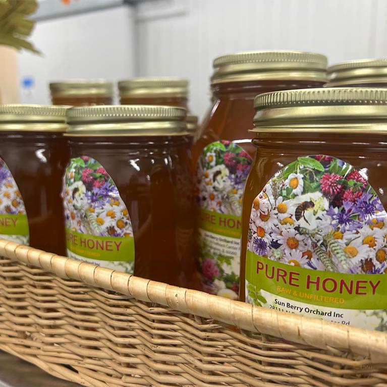 Jars of pure raw honey in a wicker basket