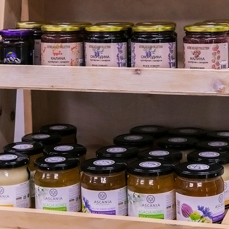 Jars of honey and fruit jam on shelves