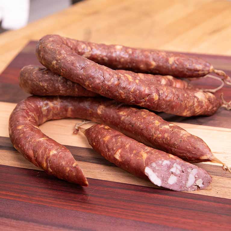Smoked sausages on wooden cutting board