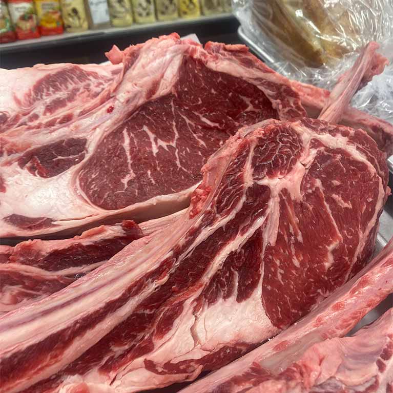 Raw beef ribeye steaks at a butcher shop