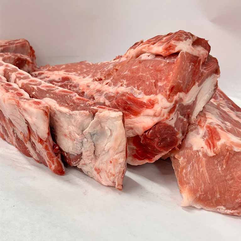 Fresh raw pork ribs on white surface