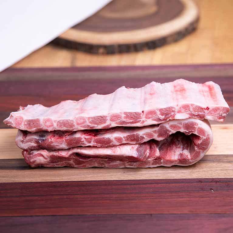 Raw pork ribs on wooden cutting board