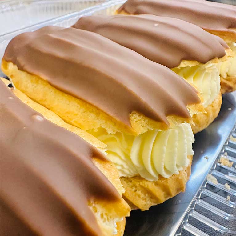 Chocolate eclairs filled with creamy vanilla custard