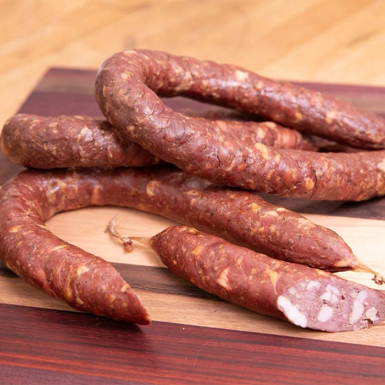 Smoked sausages on wooden cutting board