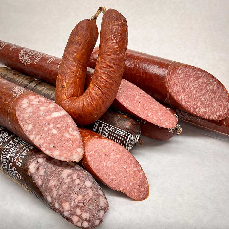 Assorted smoked sausages and salami on display
