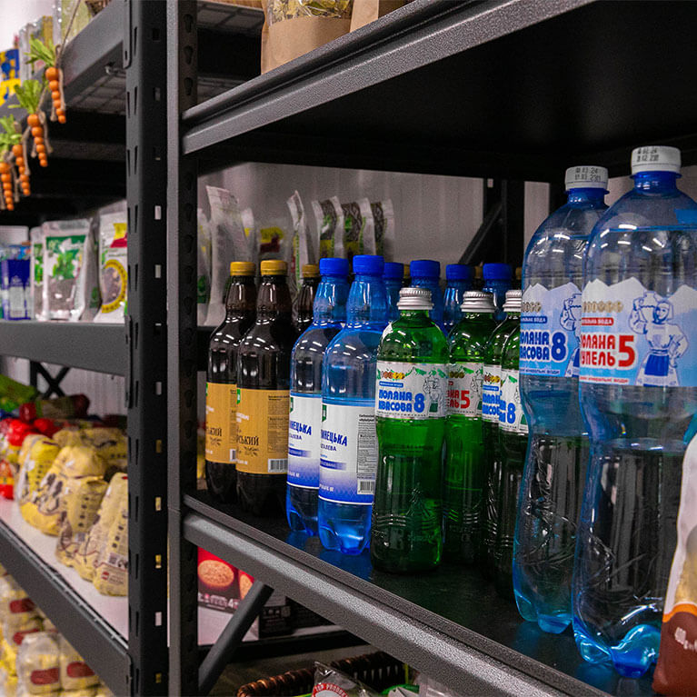Bottled drinks and groceries on store shelves